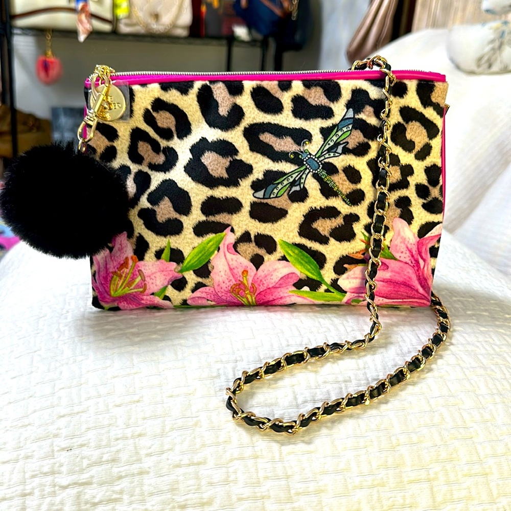 Estée Lauder beauty bag with leopard print, flowers, and a dragonfly.